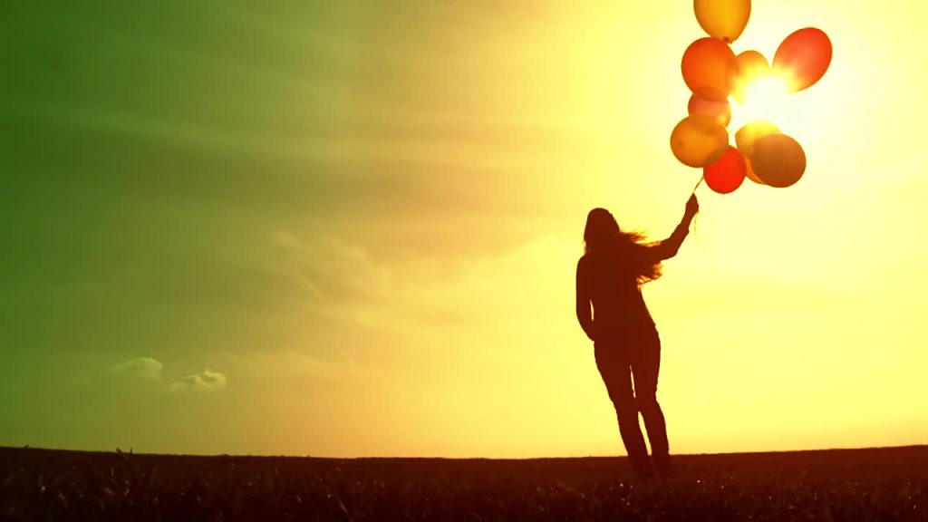 stock-footage-cheerful-happy-woman-enjoying-nature-beautiful-sky-balloons